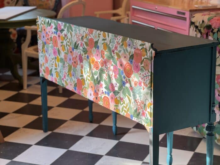Backside with wallpaper – Back of sideboard buffet covered in Rifle Paper Co floral wallpaper for living room view.
