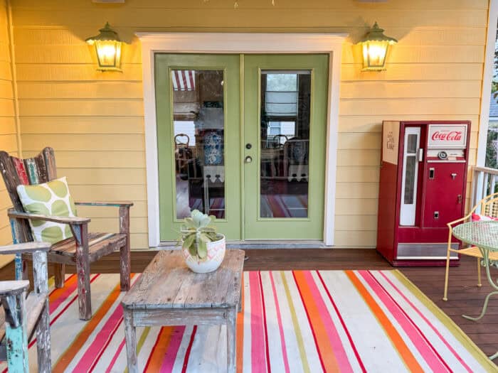 back porch french doors painted Kiwi green with green sconces