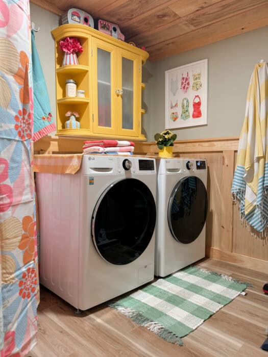 Whimsical laundry room with yellow hutch and bright accents