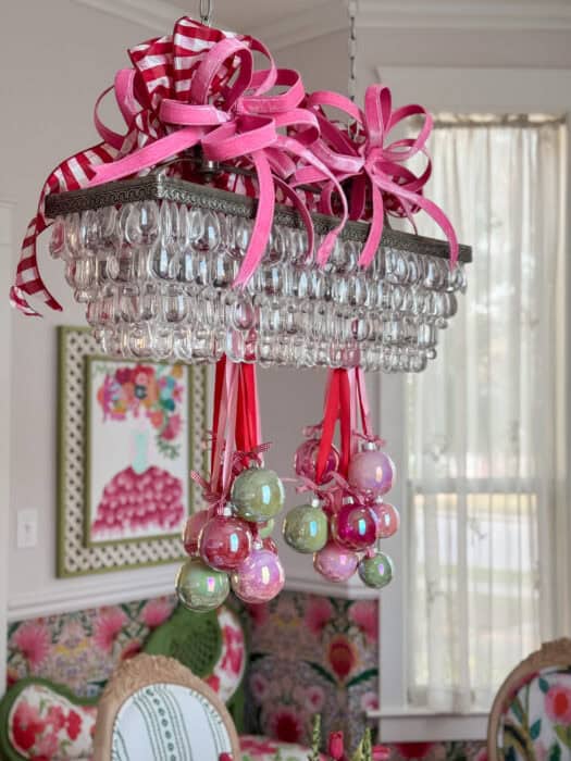 Oversized wired bows in pink and red gingham attached to the top of the chandelier for added holiday flair.