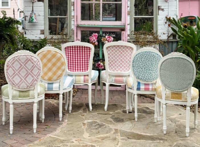 Picture of 6 chairs with different back side fabrics showing pattern mixing on dining chairs.