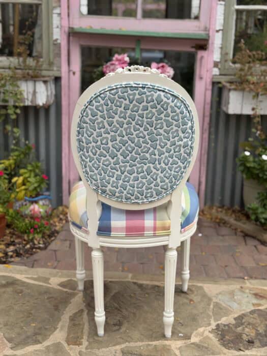 Back of chair with blue animal print and a check seat.