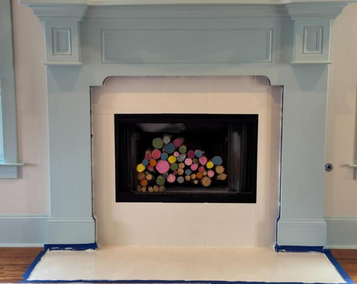 Fireplace primed with tape around the edges.