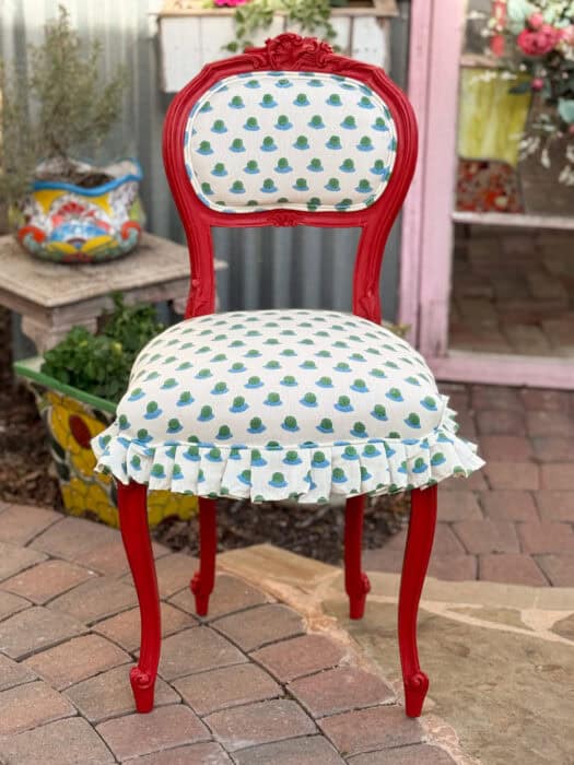 Picture of the red chair with the blue and green block printed fabric. 