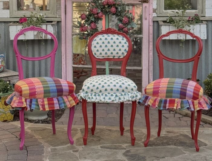 Picture of the 3 small chairs all together, two have plaid and one has the block print fabric. 