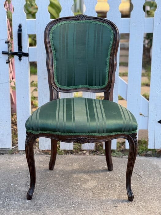 This is the before picture of the chair with a dark wood finish and green striped fabric.