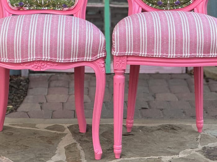 The striped seats with the pink paint on the chairs.
