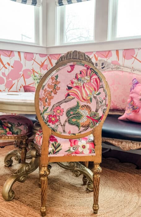 Pink floral patterned chairs at a kitchen table.