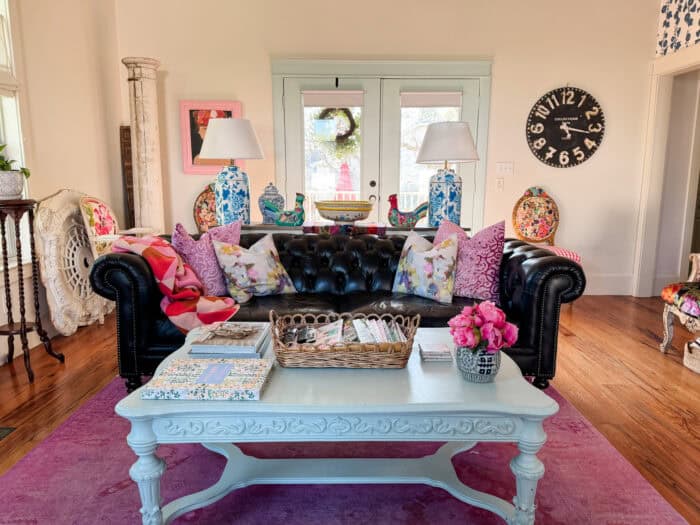 Black chesterfield sofa in a living room.