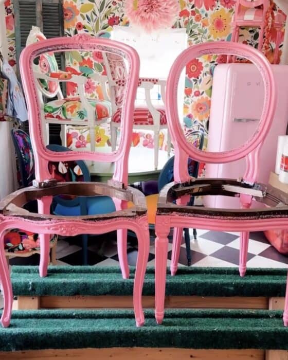 Two pink chair frames freshly painted.