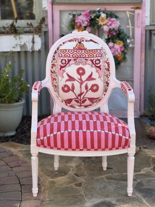 Pink painted chair with block print fabrics in red and pink.