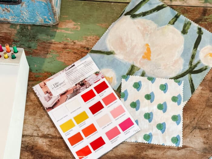 Picture of fabrics and paint on a table.