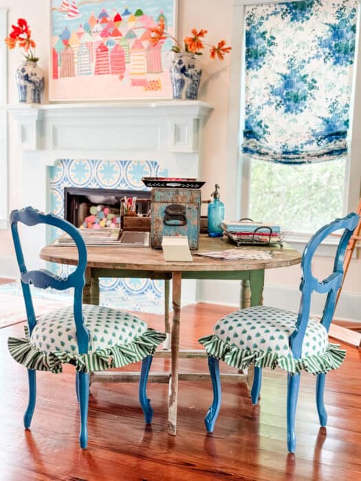 Picture of blue chairs with dot fabric and a striped skirt at a table.