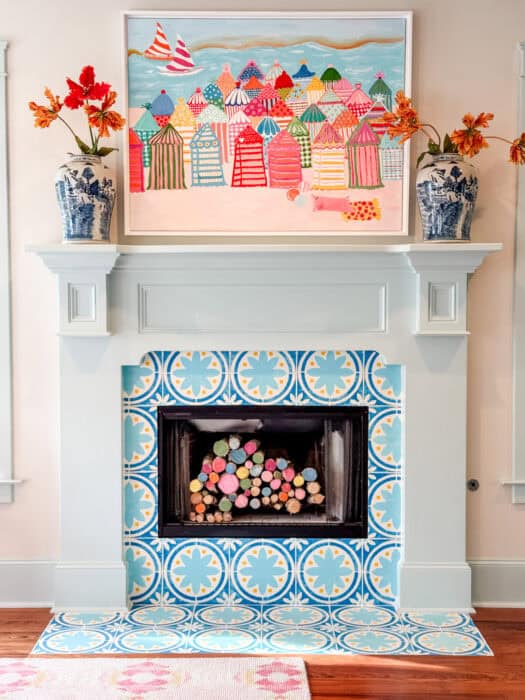 After image of fireplace stenciled in paint and artwork above.