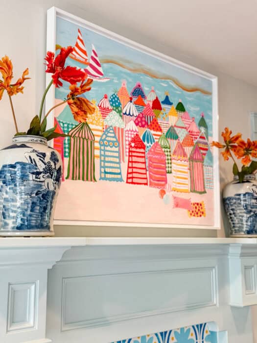 Cabana art above a fireplace.