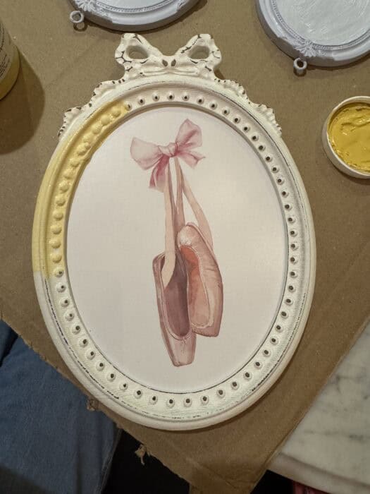 Frame with a ballet shoe painted on it.