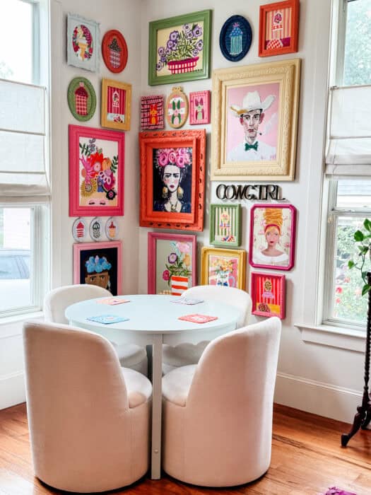Colorful gallery wall featuring original paintings of Maui, beach cabanas, and florals in a living room makeover