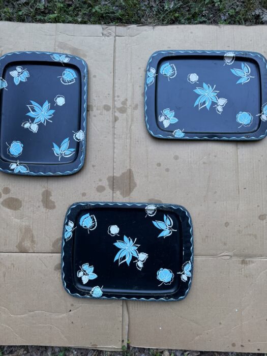 stack of vintage metal TV trays before being turned into painted TV tray tables