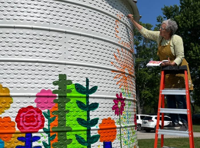 Lori Siebert painting a mural