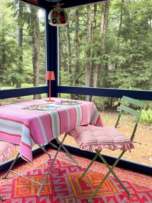 screen porch with table and chair