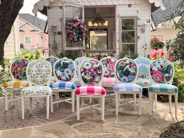 Eclectic set of colorful chairs featuring floral, scenic, and botanical prints
