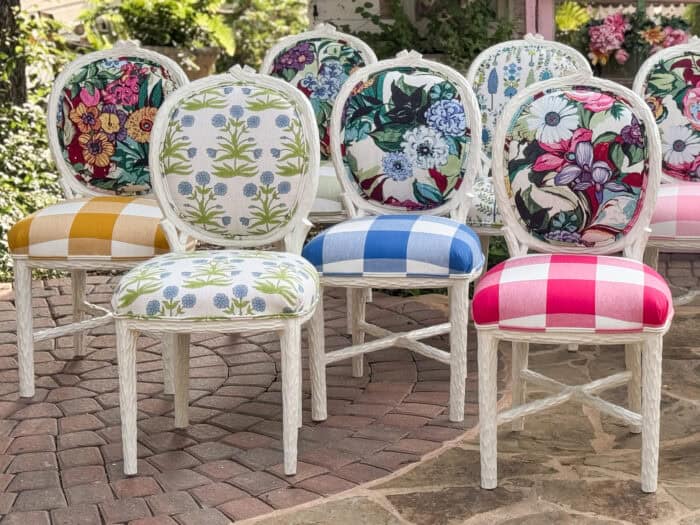 Eclectic set of colorful chairs featuring floral, scenic, and botanical prints