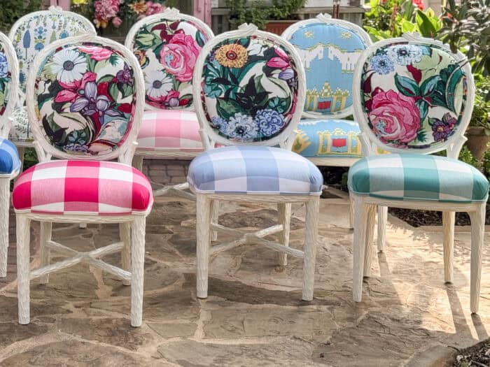 Eclectic set of colorful chairs featuring floral, scenic, and botanical prints