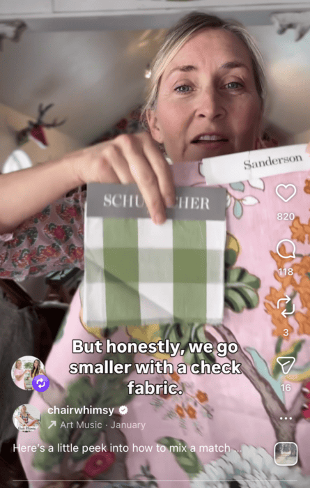 Picture showing me holding up a checked fabric with a floral fabric.