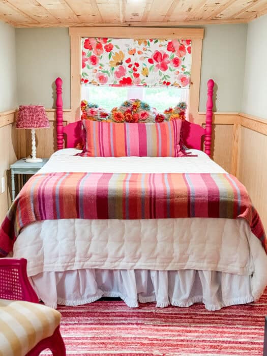Hot pink bed and floral curtains in a joyful guest bedroom retreat