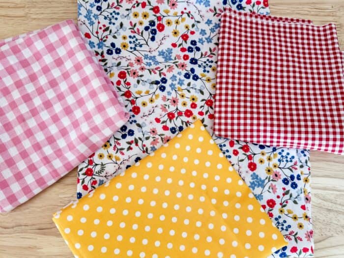 Small ditsy fabric, pink check fabric, red check fabric, and yellow polkadot fabric for the makeover.