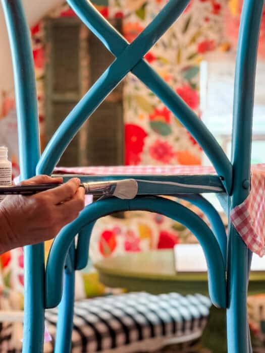Chair with glue being applied using a paintbrush