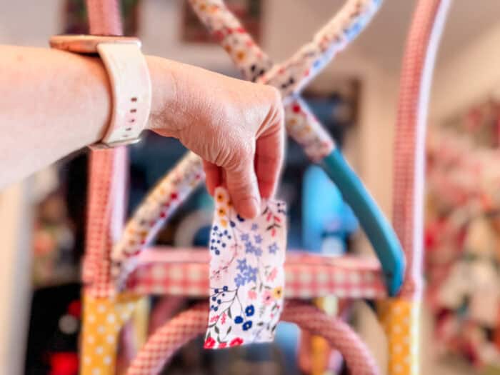A picture of a small scrap of fabric with glue ready to go on the chair.